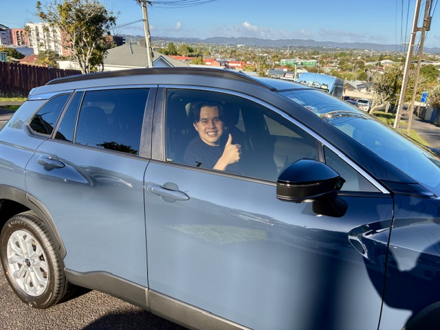 Toyota Corolla Cross, driver giving a thumbs up through the side window